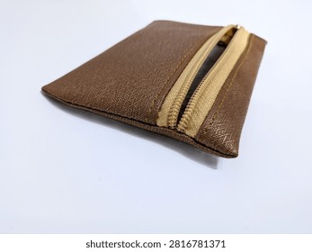Close up angled view of a fully open brown synthetic leather pouch isolated on a white background