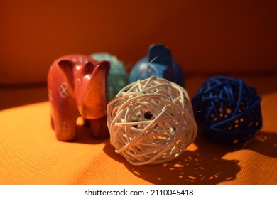 Close up of animal models on top of orange canvass and blue rattan balls with orange background