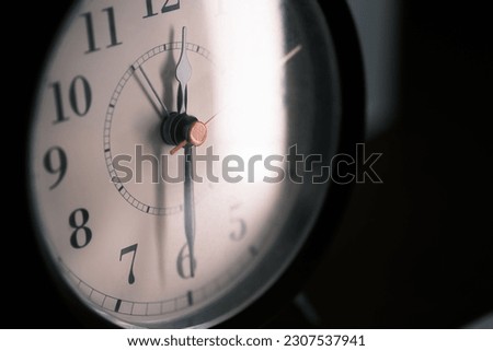 Close up of an antique clock isolated on dark background