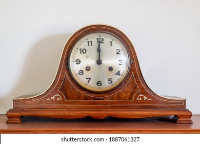 Close up of an antique clock showing 12 oclock