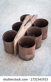 Close Up Of An Antique Homemade Rusted And Weathered Plywood And Tin Can 6 Pack Of Bins Handyman Tool Carrier Or Carpenter's Nail Holder Or Portable Part Sorter With And A Handle To Carry It With.