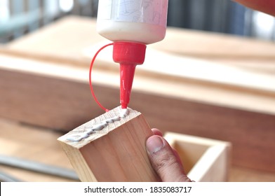 close up applying glue on the wood - Shutterstock ID 1835083717