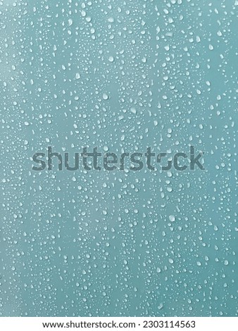 Close up aqua blue color abstract texture background of water droplets on a shower wall surface