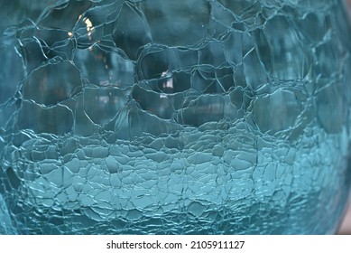 Close Up Of Aqua Blue Glass Sphere With Crackle Pattern.