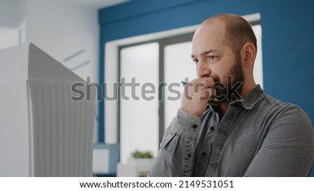 Close up of architect thinking about building strategy for construction layout. Man engineer brainstorming ideas to design urban plan while he looks at maquette in architectural office.