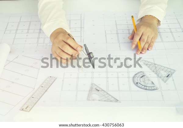 Close
up Architect working on blueprint. Architects workplace ,
architectural  working of Architect sketching a construction
project on his plane project. Construction
concept