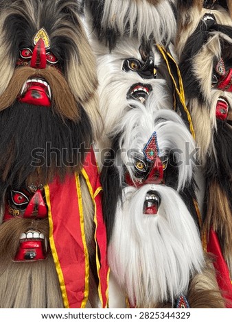Close up array of traditional Indonesian Reog Ponorogo masks known as Bujang Ganong or Ganongan. Authentic Javanese cultural folk art craftsmanship.