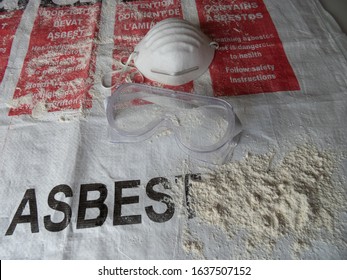 Close up of asbestos waste bag with asbestos. Text in english, french and dutch: warning, containing asbest, amiante or asbestos. Asbestos removal or removing. Goggles and facemask. Asbestosis, serie.