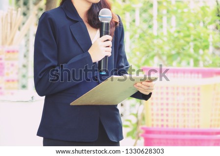 close up asia girl hand hold microphone master of ceremony annousment