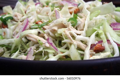 Close Up Of Asian Chicken Salad In Wood Bowl