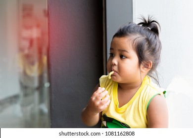 Close Up Asian Child Eat Snack With Happy