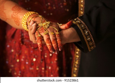 Close up of Asian couple's hands at a wedding, concept of marriage/partnership/commitment