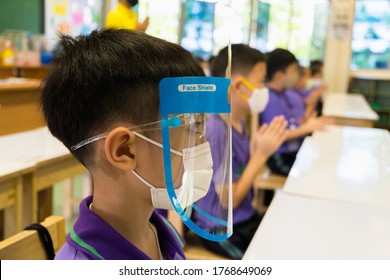 Close Up Asian Elementary School Students Wearing Hygienic Mask And Face Shield To Prevent The Outbreak Of Covid 19 In Classroom While Back To School Reopen Their School, New Normal For Education Con