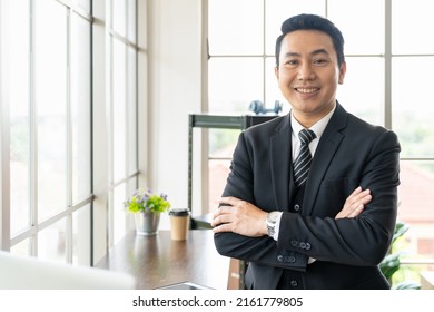 Close Up Of Asian Executive Business Man Wear Suite At The Workspace Office. Happy Asian Business Man With Laptop Computer And Background Office