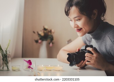 Close Up Asian Female Freelancer Photographing With A Camera In Casual Clothes. Female Photographer Working In A Studio. Hobby Side Hustle Job Creative Artist. Content Creator For Commercial Company.