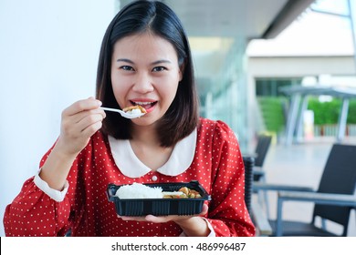 Close Up Asian Girl Have Lunch And Showing Food Box Set Pack Eating Fired Chicken With Rice At Outside Restaurant For Good Health Concept.