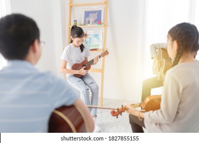 Close Up Asian Girl Play Ukulele, Asian  Children Learning And Training Music Education In Classroom, She Feeling Happy And Smile In Training Time