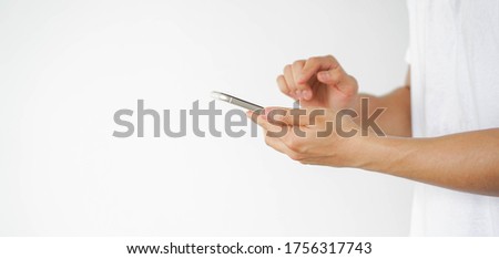 Close up asian man using smart phone mobile device for play or shopping online or check time and date , teenager with technology and social distance concept