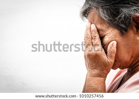 close up asian old woman hiding face with her hands