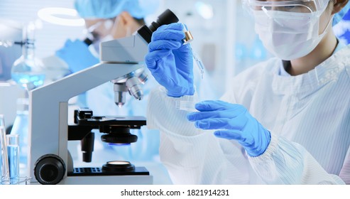 close up of asian scientist team about skin care and cosmetic product conduct experiments in the laboratory - Powered by Shutterstock