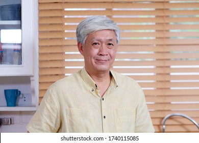 Close up of asian senior man smiling and looking at camera, Happy old asia male stay at home, Active ederly, retirement lady express positive emotion while stay home