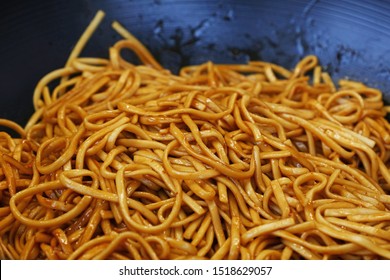 Close Up Asian Stir Fried Egg Noodles With Soy Sauce In Wok Pan, High Angle View