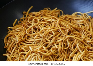 Close Up Asian Stir Fried Egg Noodles With Soy Sauce In Wok Pan, High Angle View