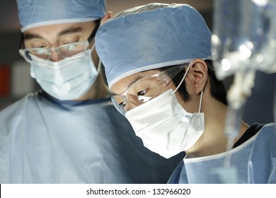 Close Up Of Asian Surgeon Working With Assistant In Surgery