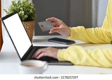 Close Up Of Asian Woman In Casual Outfit Entering Typing Credit Card Number On Laptop To Purchase Items From An Online Store, Order Food, Pay Bills.