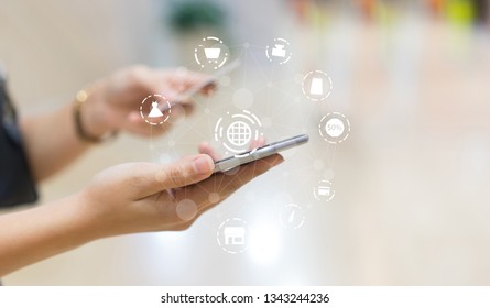 close up asian woman using smartphone mobile for make payment of credit card at home office with virtual interface of shopping online (b2b) technology concept