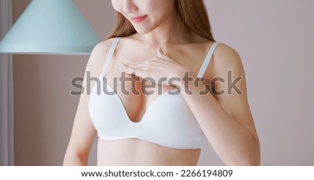 close up of asian asian woman wearing bra at home