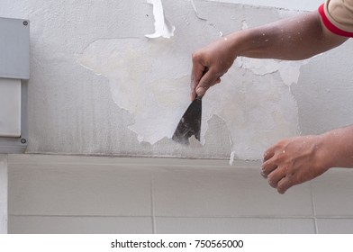 Close Up Asian Worker Hand Scrape Old Paint From Cement Wall By Putty Trowel