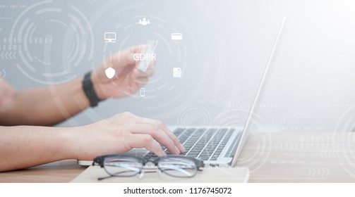 Close Up Asian Working Man Use Credit Card For Payment On Laptop At Home Office With Virtual Interface Of GDPR (General Data Protection Regulation ) , Privacy Personal Data Concept