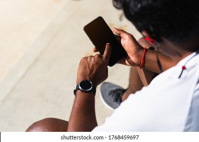 Close up Asian young athlete sport runner black man wear modern time smart watch and sync to a smartphone check running result after training run at the outdoor, healthy exercise workout technology - Powered by Shutterstock