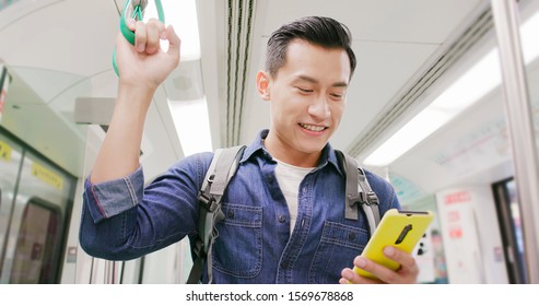 Close Up Of Asian Young Man Use 5g Smartphone On The Mrt Or Train