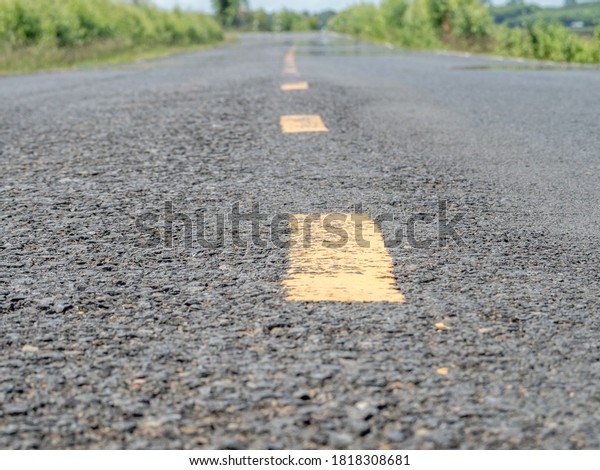 close up Asphalt and dashed roads dividing\
lanes, country roads\
Thailand