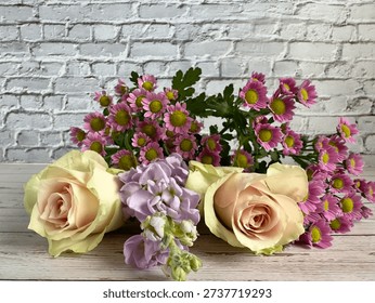 Close Up Of Assorted Spring Flowers On Light Horizontal Background Including Chrysanthemums Lilac Stock Flowers And Peach Pink Roses With Copy Space
