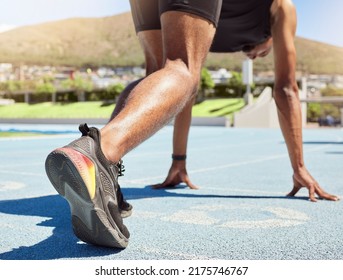 Close Up Of An Athlete Getting Ready To Run Track And Field With His Feet On Starting Blocks Ready To Start Sprinting. Close Up Of A Man In Starting Position For Running A Race On A Sports Track