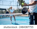 Close up of athlete serving the ball while playing paddle tennis. Copy space. 