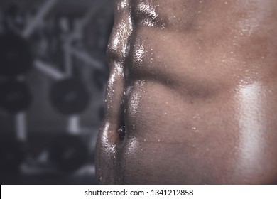 Close Up Of An Athletic Man With A Bulging Body Bump Muscle After Workout At Gym Center