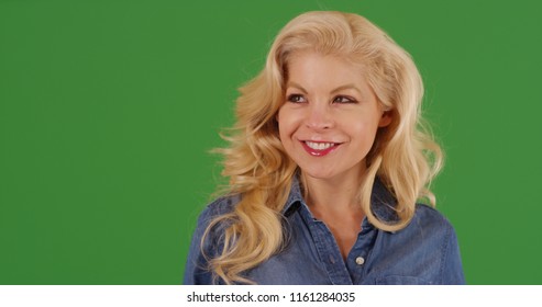 Close up of attractive blonde woman looking around smiling on green screen - Powered by Shutterstock