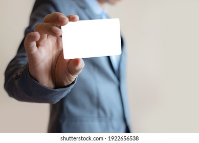 Close Up Attractive Business Man Holding Blank White Mock Up Card In Hand.