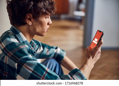 Close up of attractive guy holding cellphone with 911 on display stock photo