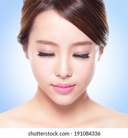 close up of attractive Skin care woman face relax closed eyes with blue background, asian beauty