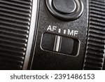 Close up of the auto or mannual focus button on the new camera lens. Af and mf switch on the camera lens, controls of a mirrorless camera, macro