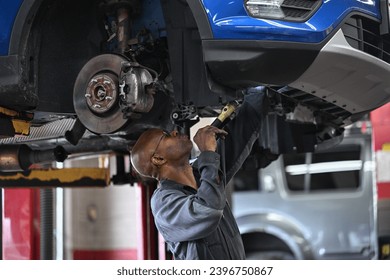 close up of auto mechanic working on brake rotors 