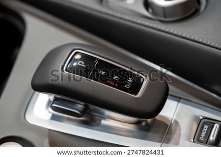 Close up of automatic gear selector inside car.