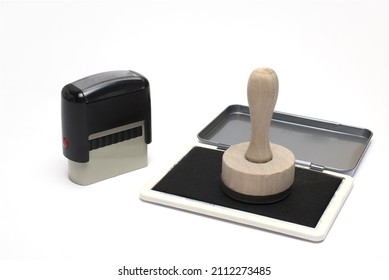 Close Up Of Automatic Next Wooden Stamp On Black Ink Pad On White Background