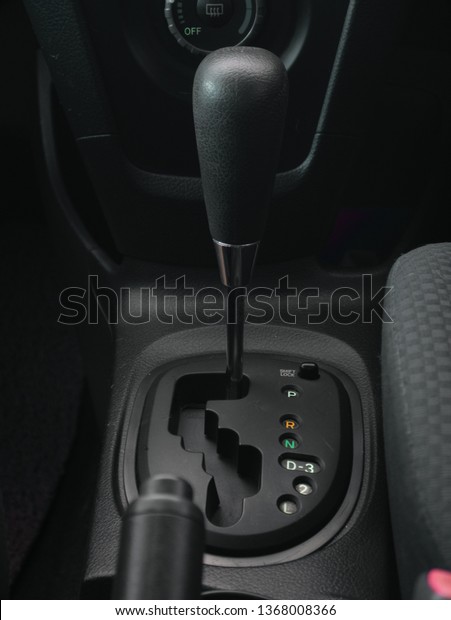 Close up of automatic\
transmission car. Gate type gear stick with LED Backlit.\
Dark\
interior decorative.