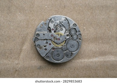close up of automatic watch movement on cardboard background                               